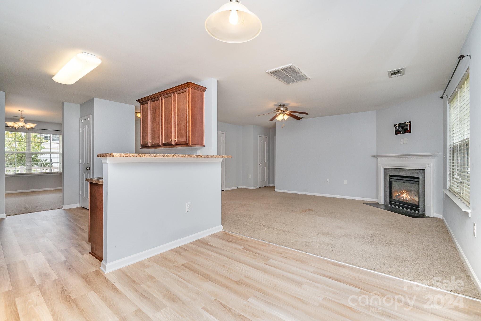 1004 Marcus Street Indian Land, SC 29707 - Photo 14 of 48 a view of a kitchen with a sink cabinets and a fireplace