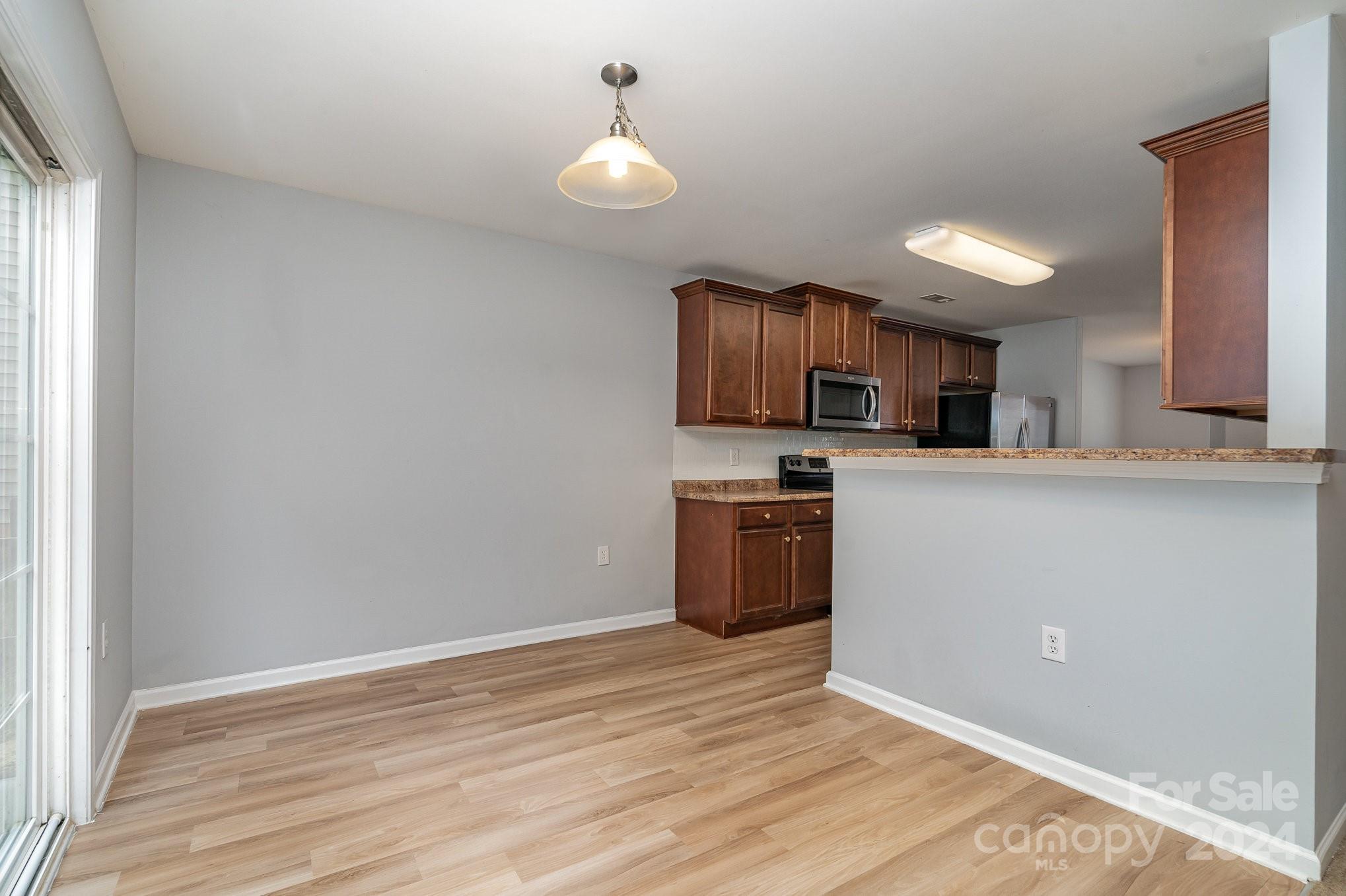 1004 Marcus Street Indian Land, SC 29707 - Photo 17 of 48 a kitchen with kitchen island granite countertop a sink cabinets and stainless steel appliances