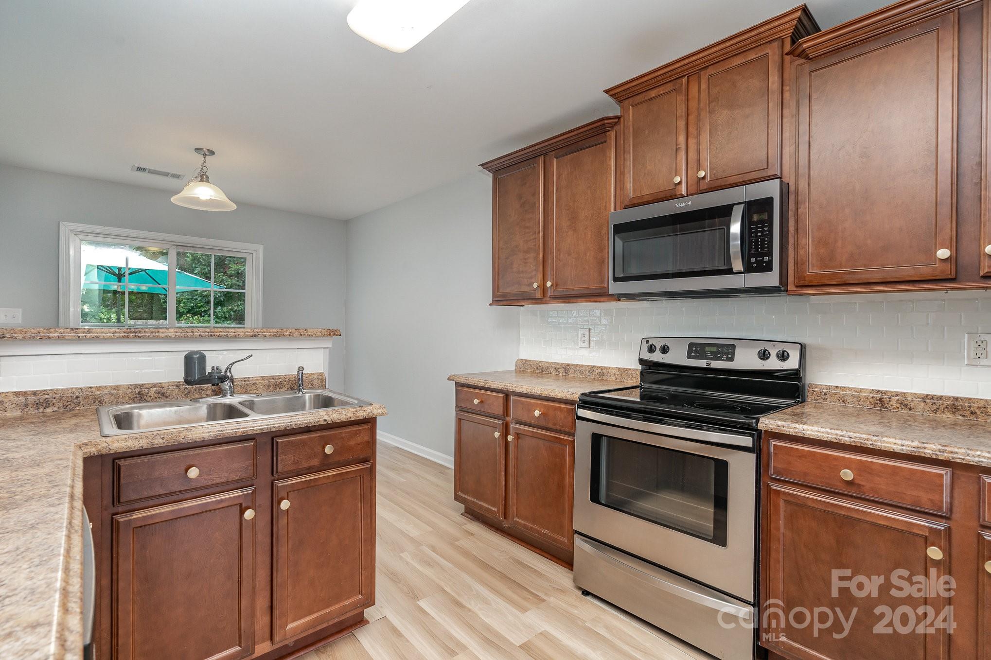 1004 Marcus Street Indian Land, SC 29707 - Photo 19 of 48 a kitchen with a sink stove and microwave