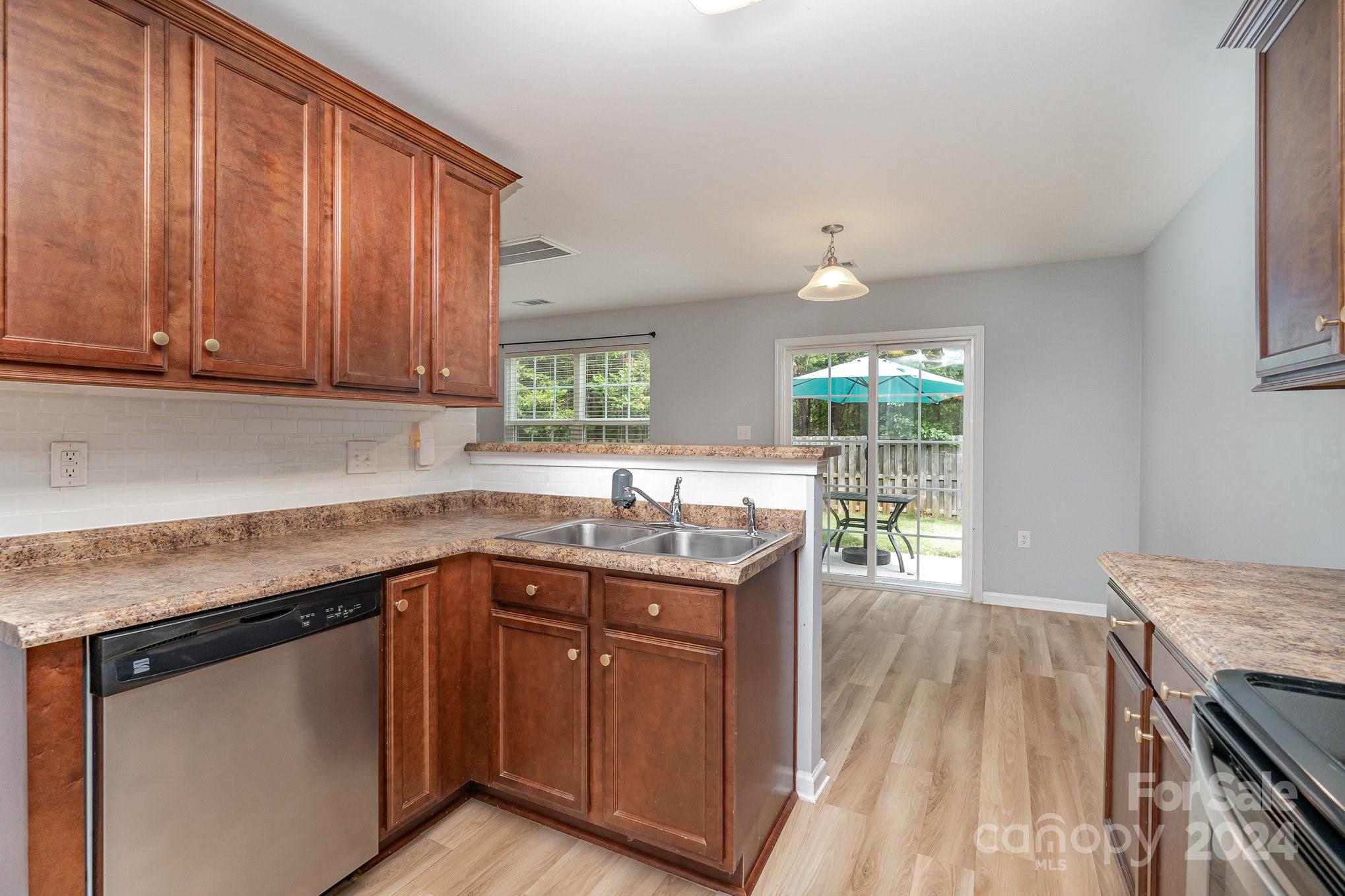 1004 Marcus Street Indian Land, SC 29707 - Photo 20 of 48 a kitchen with granite countertop sink stove and cabinets