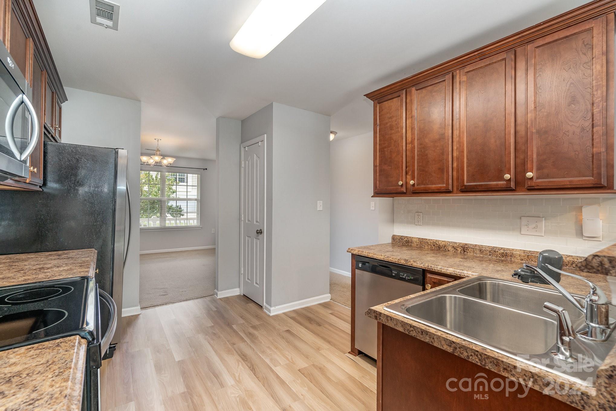1004 Marcus Street Indian Land, SC 29707 - Photo 21 of 48 a kitchen with a sink cabinets and stainless steel appliances