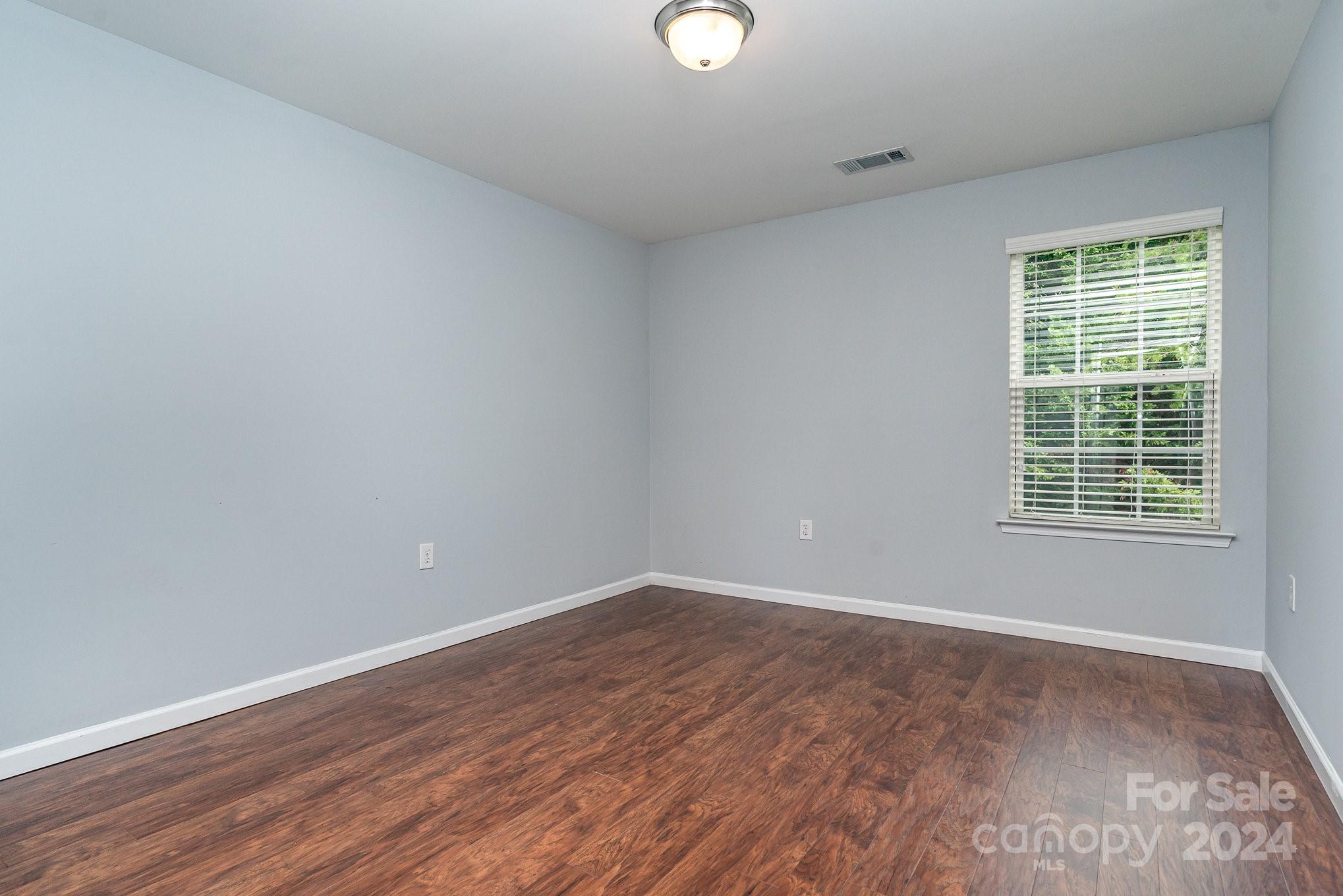 1004 Marcus Street Indian Land, SC 29707 - Photo 22 of 48 an empty room with wooden floor and windows