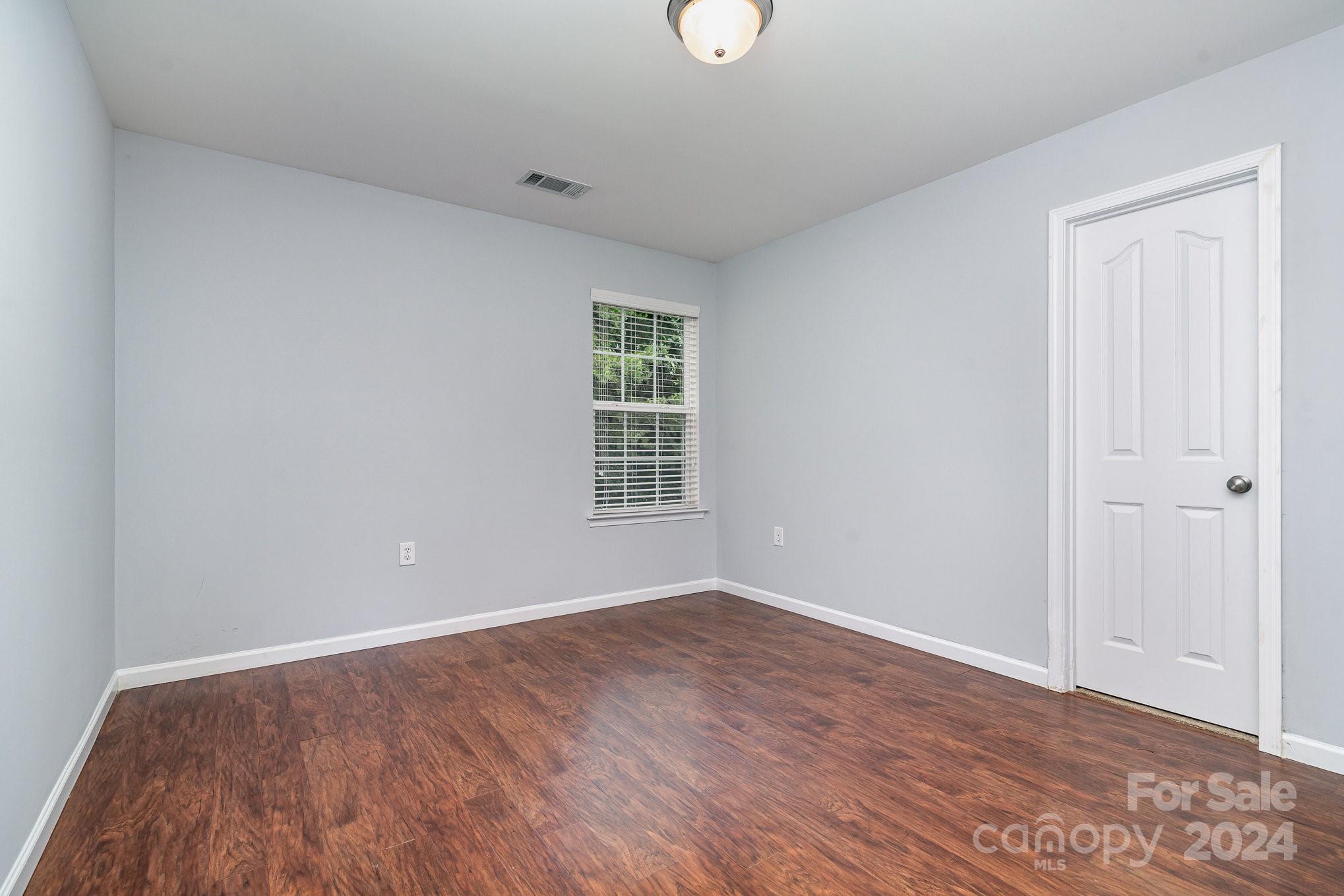 1004 Marcus Street Indian Land, SC 29707 - Photo 24 of 48 an empty room with wooden floor and windows