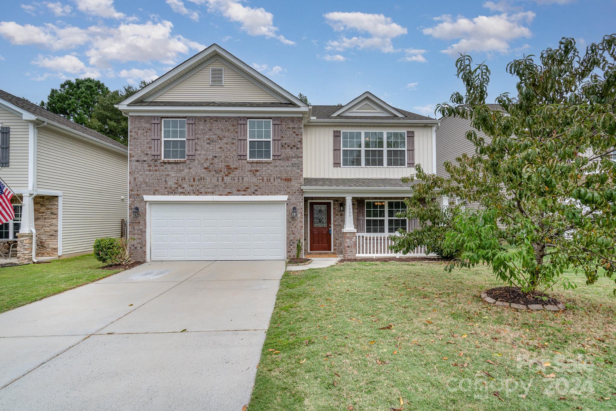 1004 Marcus Street Indian Land, SC 29707 - Photo 3 of 48 a front view of a house with a yard and garage