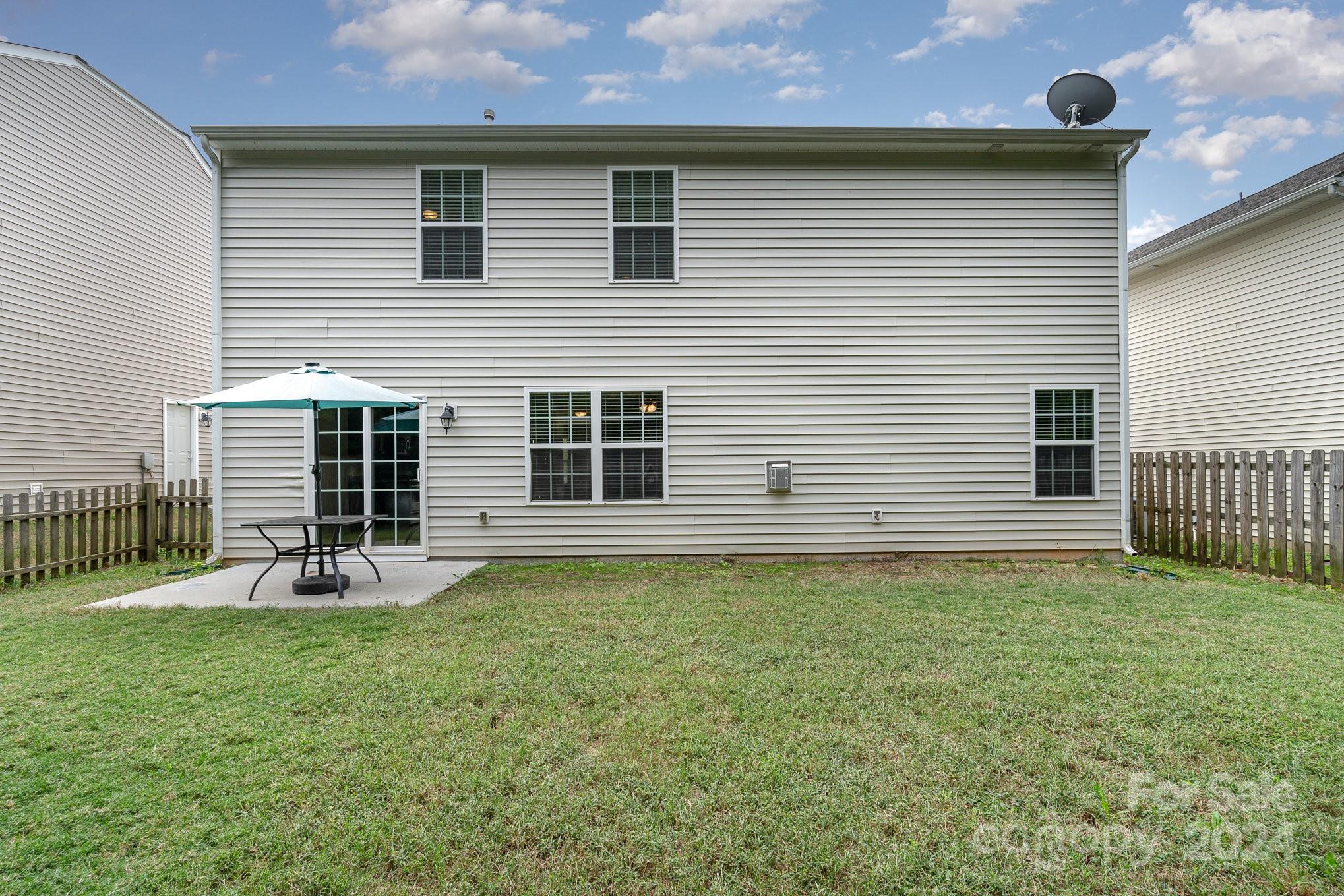 1004 Marcus Street Indian Land, SC 29707 - Photo 41 of 48 a backyard of a house with table and chairs