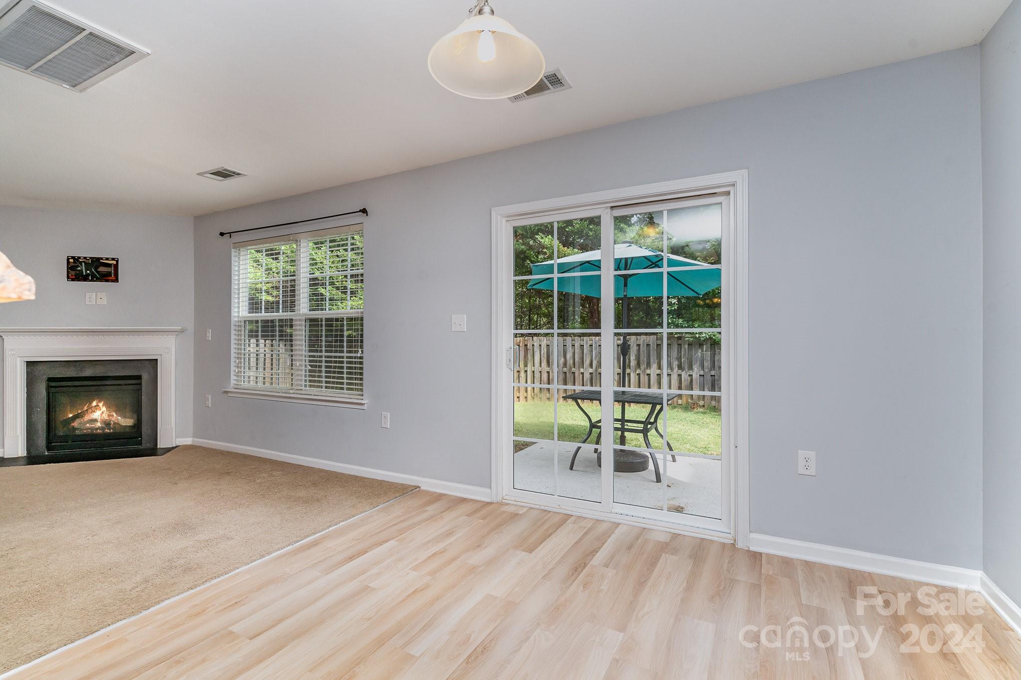 1004 Marcus Street Indian Land, SC 29707 - Photo 10 of 48 an empty room with windows and fireplace