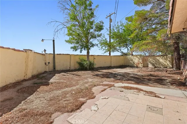 a kitchen with stainless steel appliances kitchen island granite countertop a sink stove and refrigerator