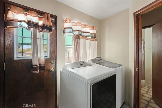 a view of a hallway with wooden floor and living room