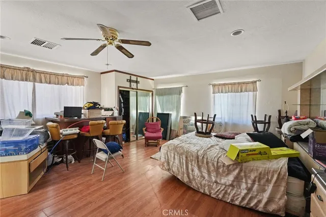 a bedroom with a bed and a dresser in it