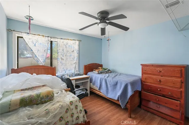 a bedroom with bed and glass door