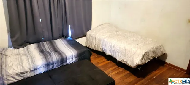 a bed sitting in a bedroom next to a window