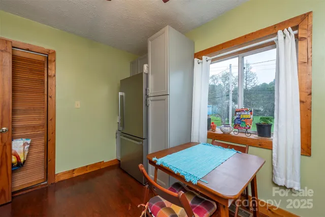 a room with stainless steel appliances kitchen island granite countertop a sink stove and cabinets