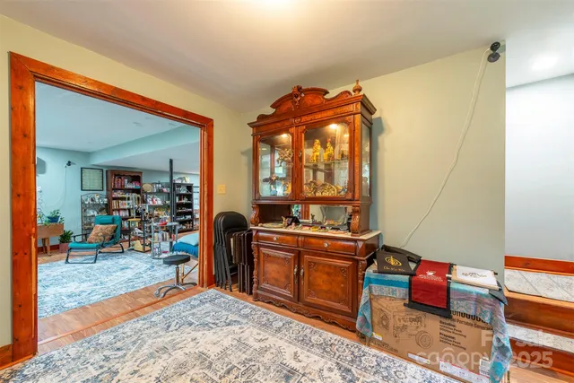 a spacious bedroom with a bed and a chandelier
