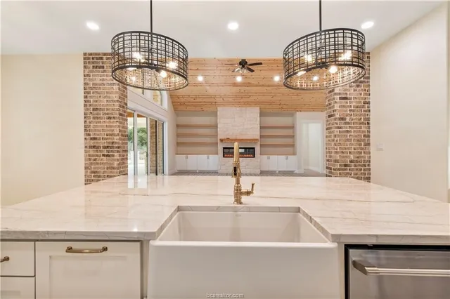 a kitchen with a sink cabinets and chandelier