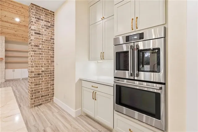 a kitchen with cabinets and stainless steel appliances
