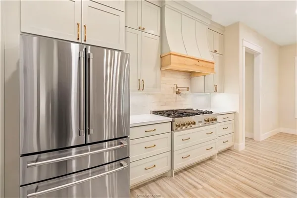 a kitchen with stainless steel appliances a stove and a refrigerator