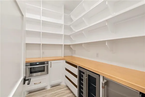 a kitchen with stainless steel appliances kitchen island granite countertop a stove and a wooden floors