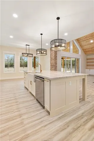 a bathroom with a granite countertop toilet sink and mirror