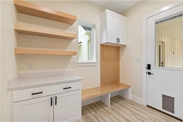 a spacious bathroom with a granite countertop sink mirror and bathtub