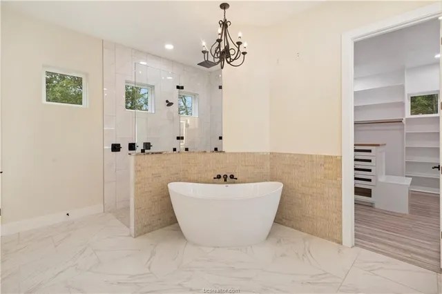 a bathroom with a tub sink and mirror