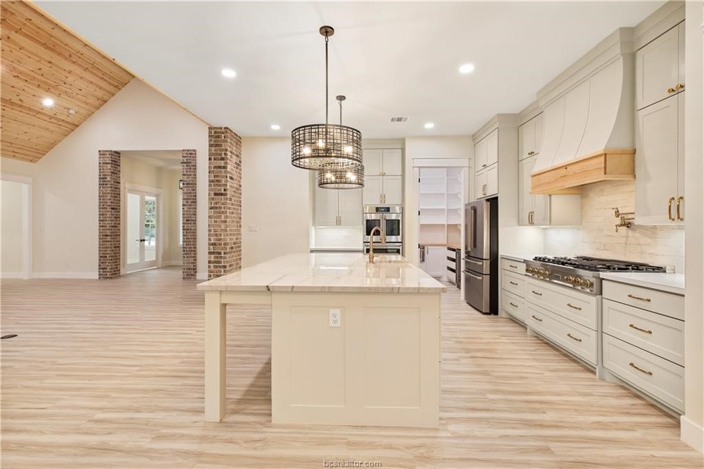 Lot 9 Old Hickory Trail Franklin, TX 77856 - Photo 8 of 41 a large kitchen with granite countertop a stove and a sink