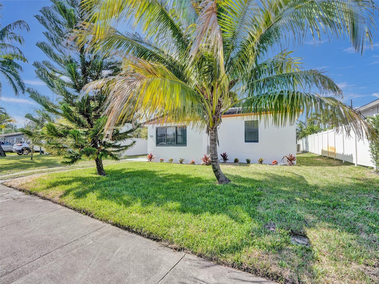 905 Southwest 22nd Street Fort Lauderdale, FL 33315 - Photo 2 of 25 a front view of house with yard and green space