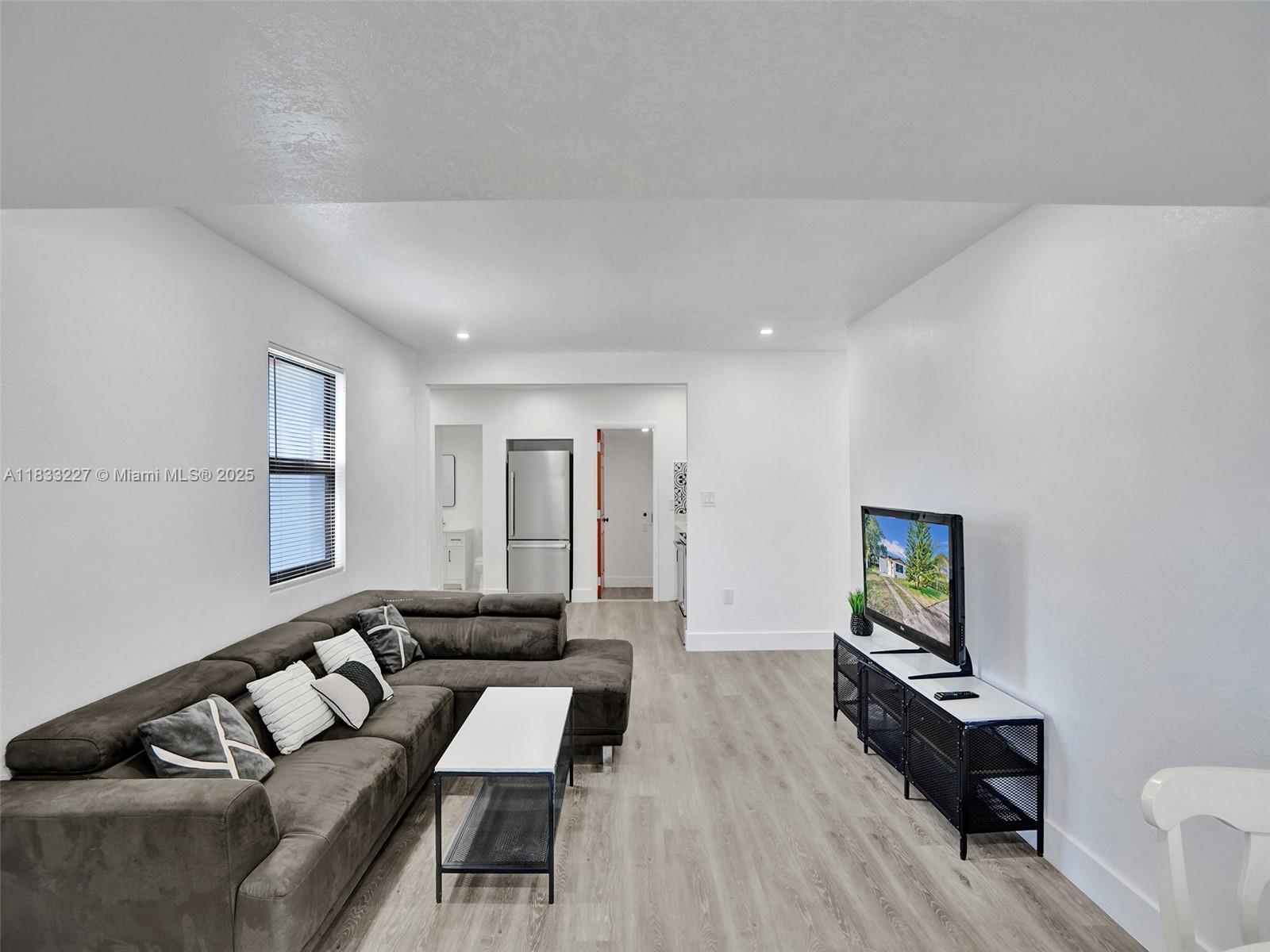905 Southwest 22nd Street Fort Lauderdale, FL 33315 - Photo 7 of 25 a living room with furniture and a flat screen tv