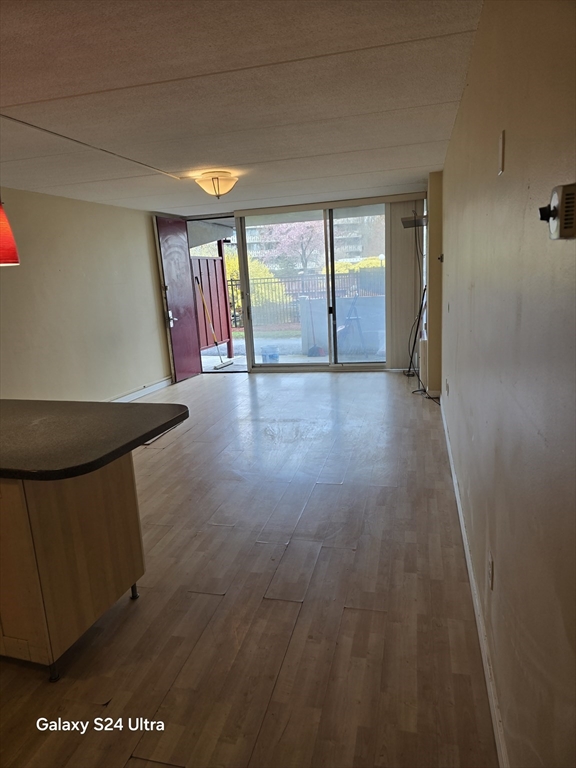 200 Swanton Street, Unit T35 Winchester, MA 01890 - Photo 23 of 36 wooden floor in an empty room with a window