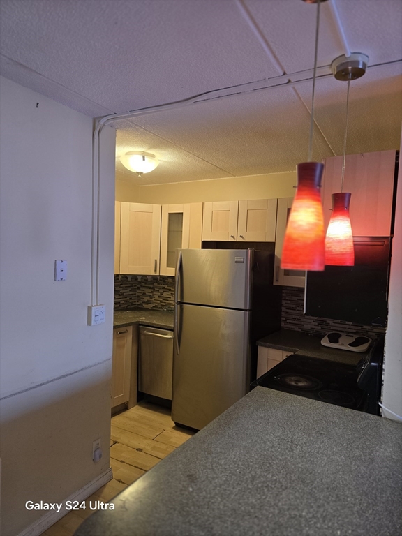 200 Swanton Street, Unit T35 Winchester, MA 01890 - Photo 3 of 36 a kitchen with a refrigerator and a flat screen tv