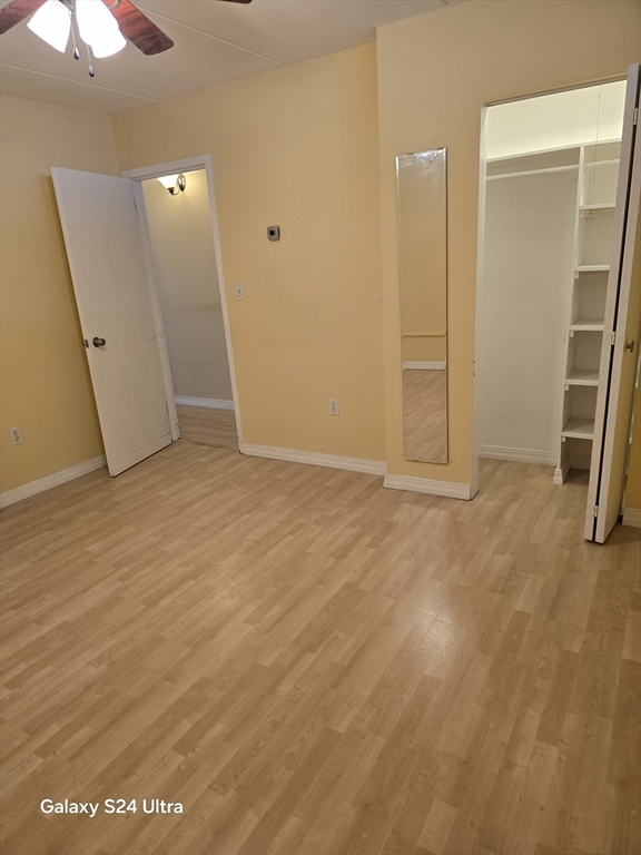 200 Swanton Street, Unit T35 Winchester, MA 01890 - Photo 32 of 36 an empty room with wooden floor and a ceiling fan