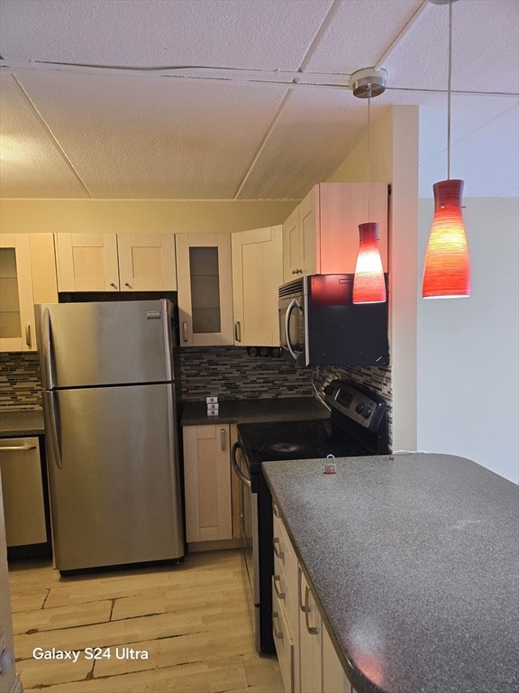 200 Swanton Street, Unit T35 Winchester, MA 01890 - Photo 35 of 36 a kitchen with a sink appliances and cabinets