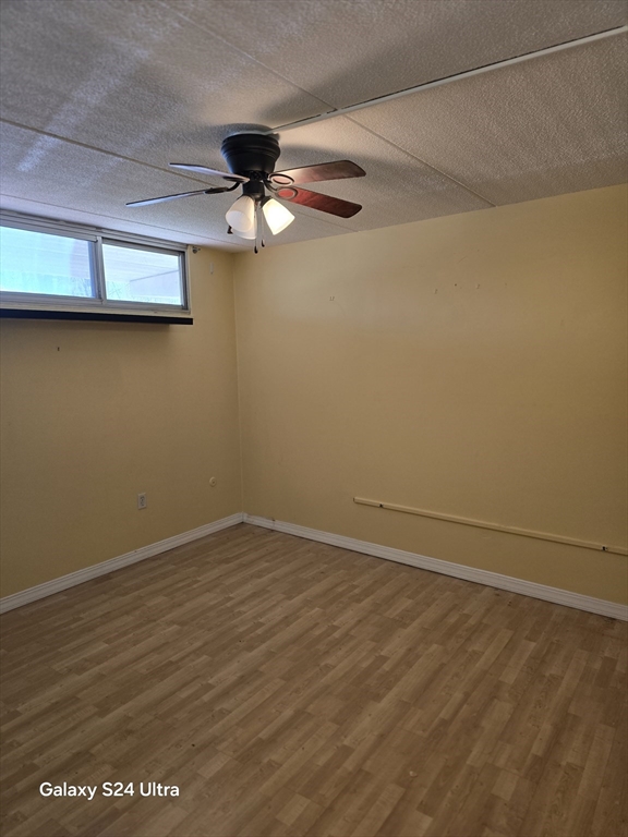 200 Swanton Street, Unit T35 Winchester, MA 01890 - Photo 8 of 36 en empty room with wooden floor and fan