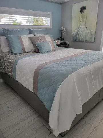 a bedroom with a bed and window