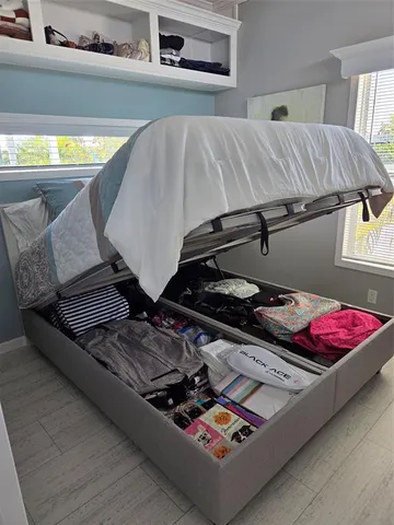 a bed sitting next to a window