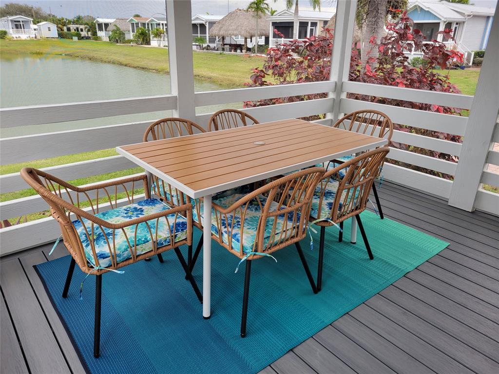 617 Southwest 34th Cove Okeechobee, FL 34974 - Photo 14 of 39 a roof deck with a table and chairs with wooden floor