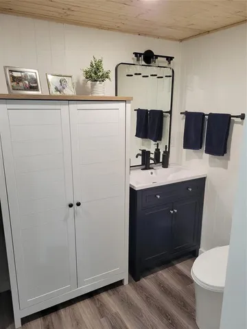 a spacious bathroom with a toilet sink and mirror