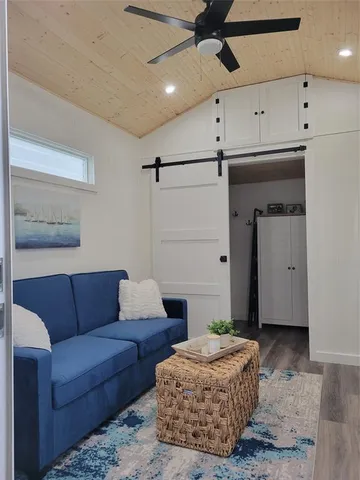 a living room with furniture and a ceiling fan