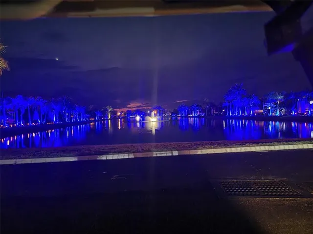 a living room with a couch and a bookshelf with wooden floor