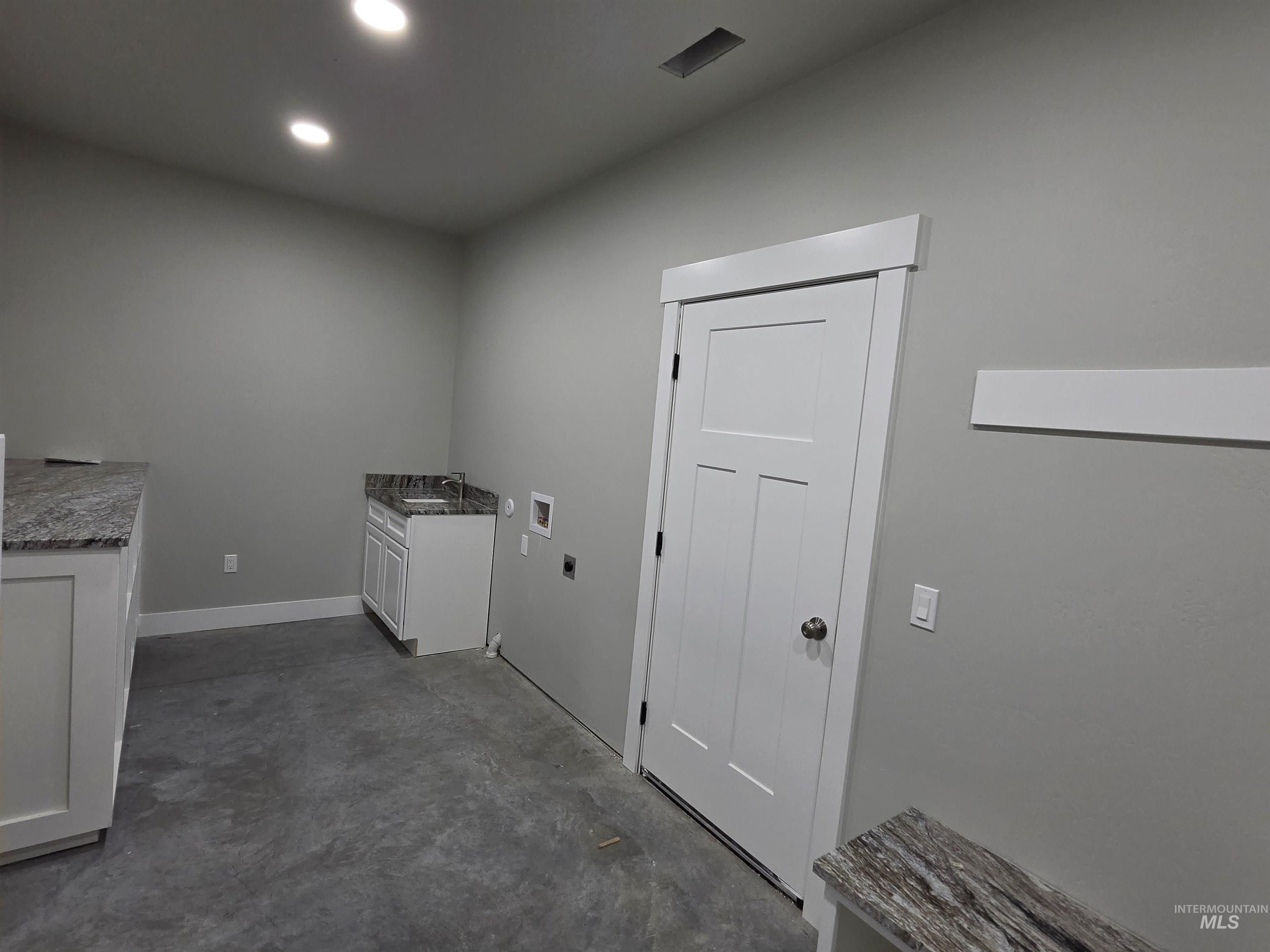 39 Lakeside Loop Burley, ID 83318 - Photo 11 of 15 Laundry room featuring concrete floors, washer hookup, cabinet space, hookup for an electric dryer, and recessed lighting