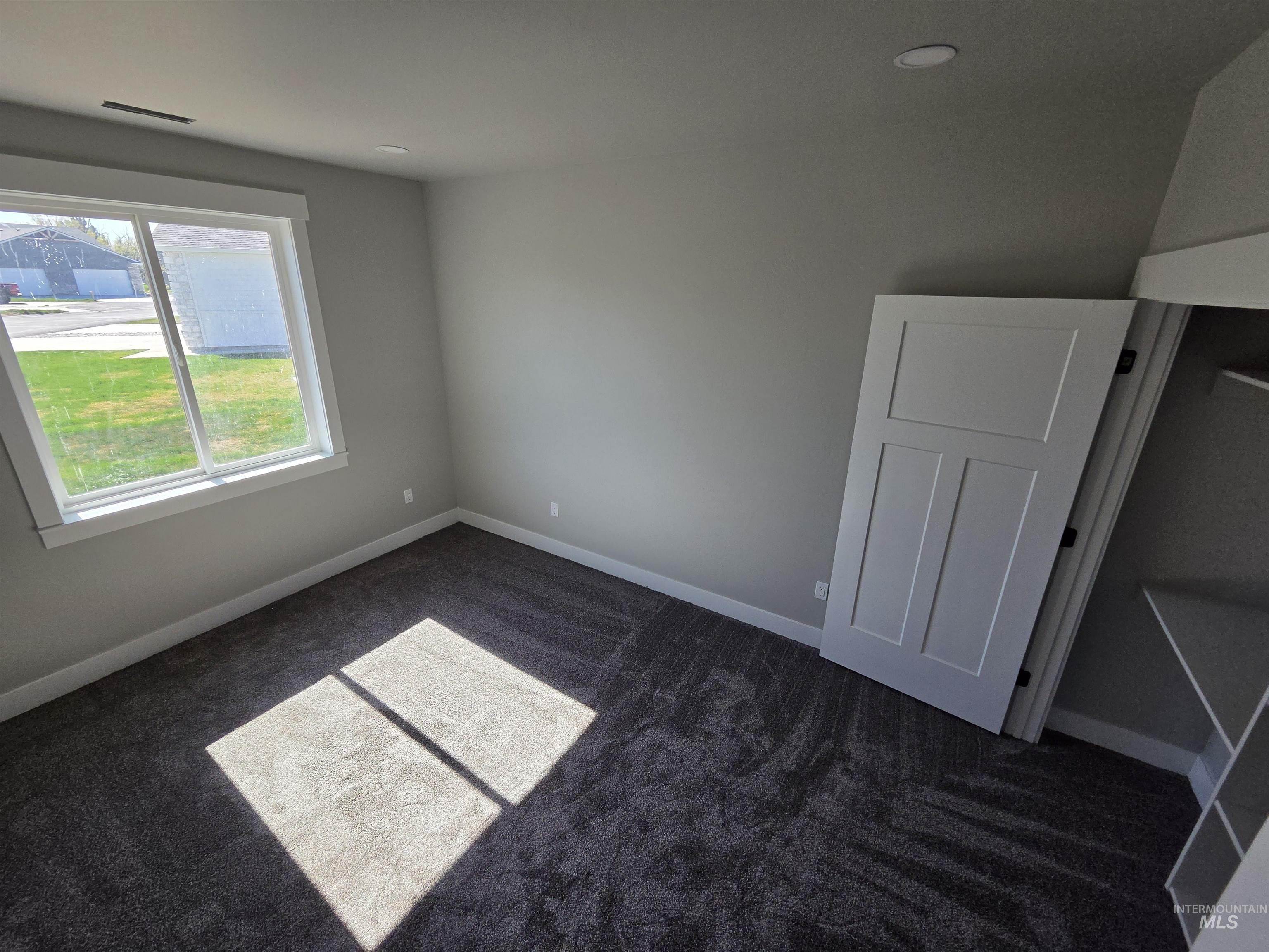 39 Lakeside Loop Burley, ID 83318 - Photo 4 of 15 Unfurnished bedroom featuring dark carpet and baseboards