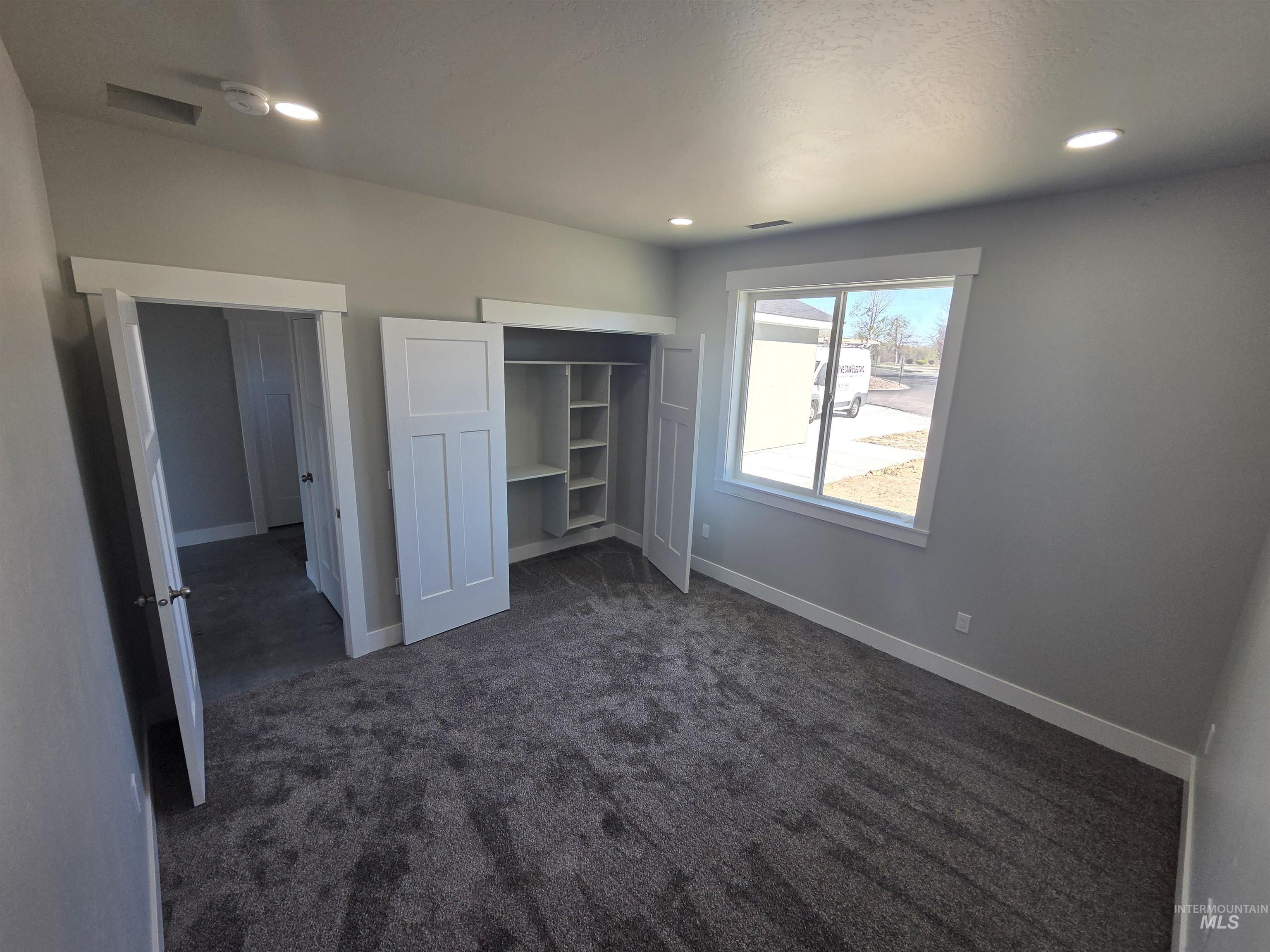 39 Lakeside Loop Burley, ID 83318 - Photo 5 of 15 Unfurnished bedroom featuring dark carpet, a closet, and recessed lighting