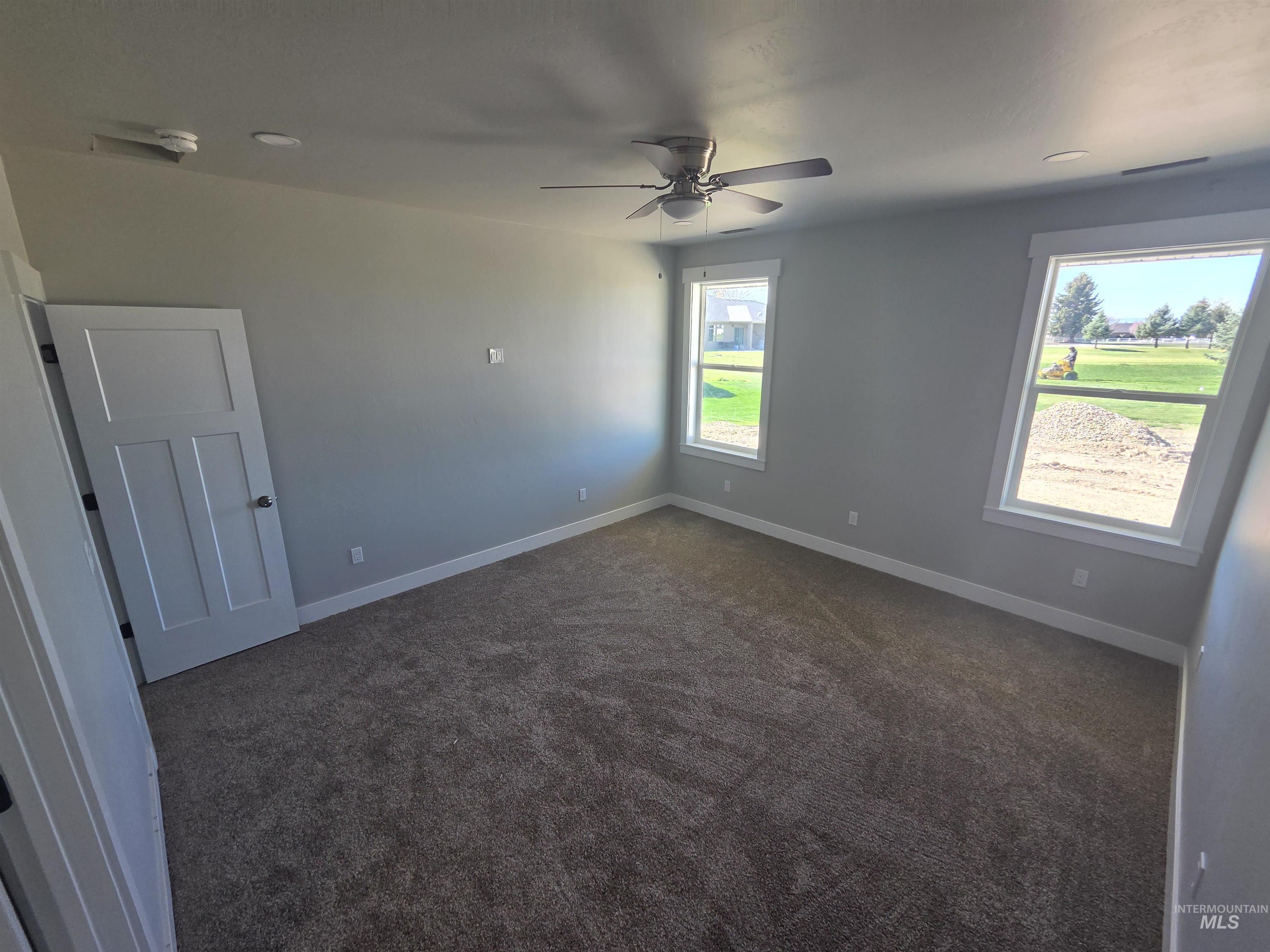 39 Lakeside Loop Burley, ID 83318 - Photo 9 of 15 Spare room featuring dark carpet and ceiling fan