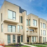 a front view of a residential apartment building with a yard