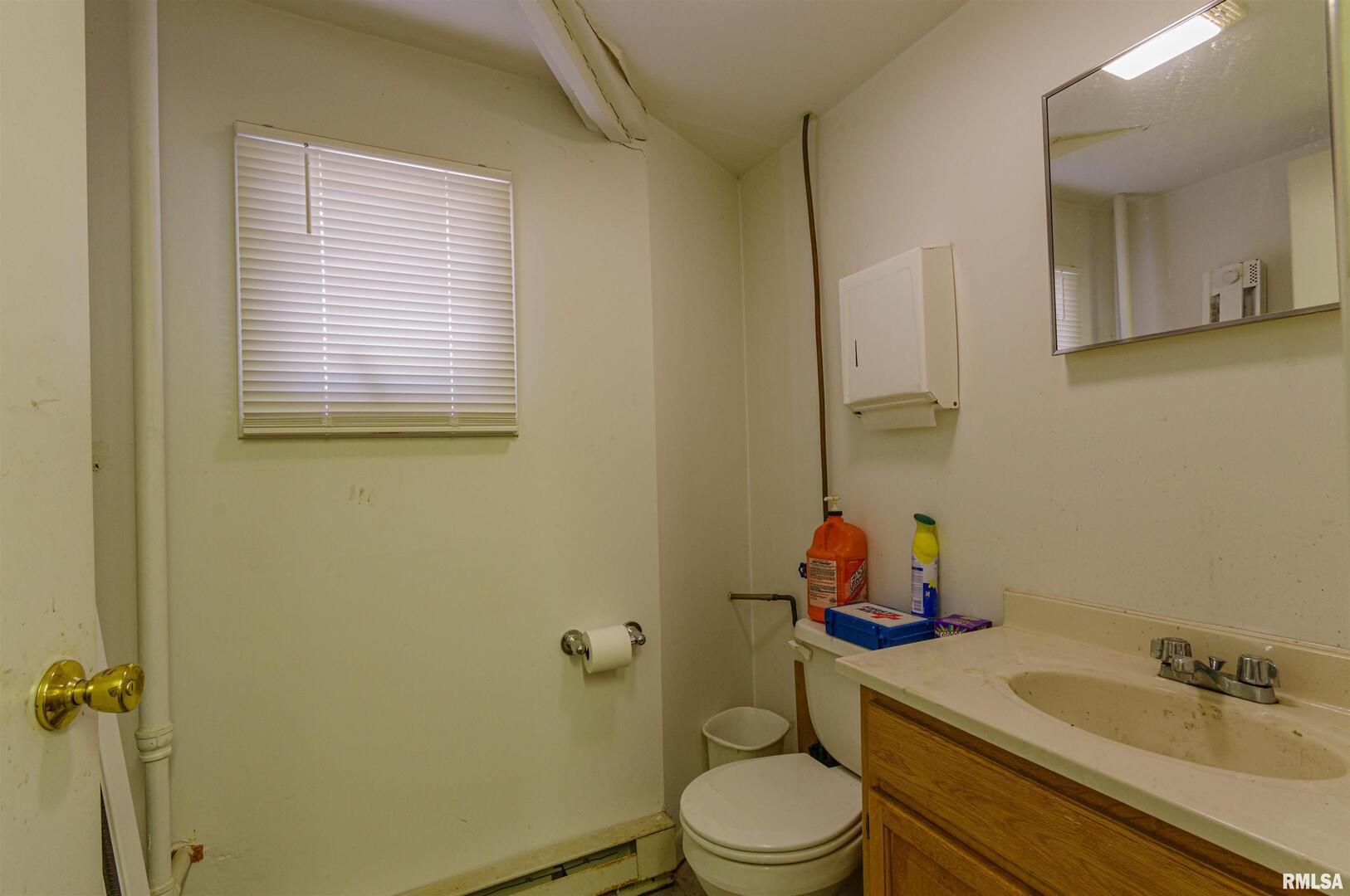 1114 South Perrine Centralia, IL 62801 - Photo 60 of 73 a bathroom with a toilet sink and mirror