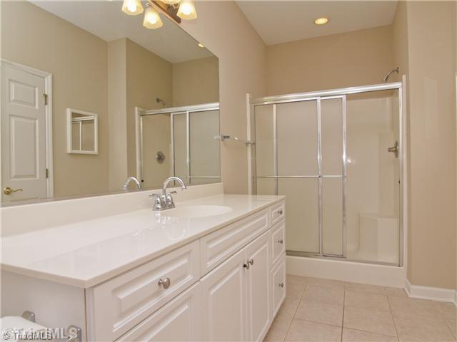 7809 Perthshire Drive Oak Ridge, NC 27310 - Photo 11 of 15 Master Bath/Spa. Look at all that counter space! No fighting for room at the mirror here! Large separate shower with seat. Lots of storage!