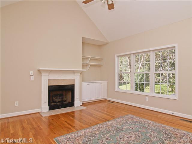 7809 Perthshire Drive Oak Ridge, NC 27310 - Photo 3 of 15 Living Room. More beautiful windows, and that private view. Gas logs make the space cozy! Built in storage and shelves add character. Vaulted ceilings give the room an even bigger feel.