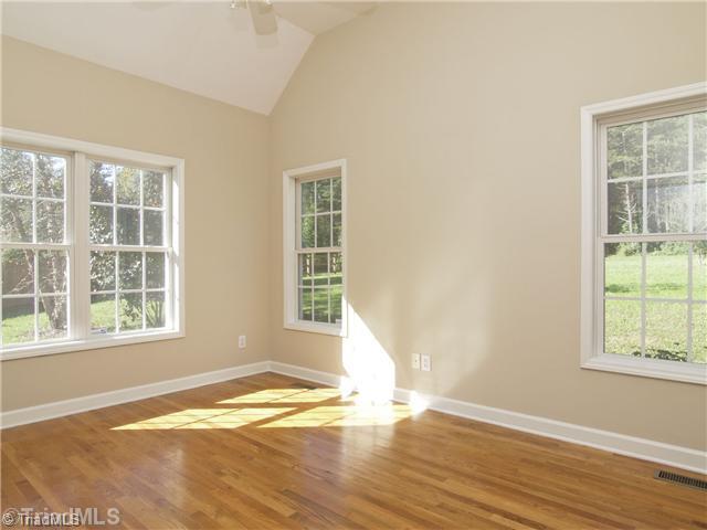 7809 Perthshire Drive Oak Ridge, NC 27310 - Photo 9 of 15 Master Bedroom. Master bedroom is its own private get away. Beautiful light, lots of windows, but still lots of privacy, and the lovely view of the large back yard.