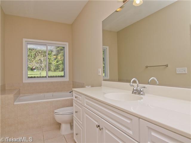 7809 Perthshire Drive Oak Ridge, NC 27310 - Photo 10 of 15 Master Bath/Spa. Tile floors, beautiful large window, lovely neutral colors. Jetted tub will help you to wind down at the end of those busy days. Separate shower too for those mornings when you don t have time to relax, but need to wake up!