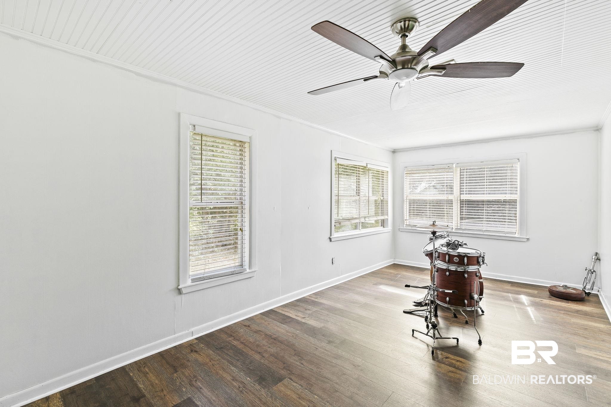 316 West Orchid Avenue Foley, AL 36535 - Photo 35 of 38 Empty room with wood finished floors, ceiling fan, healthy amount of natural light, and ornamental molding