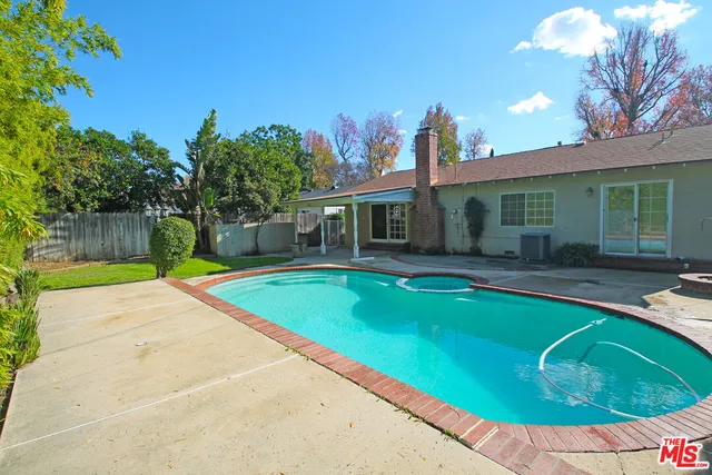 a view of a house with swimming pool and a yard
